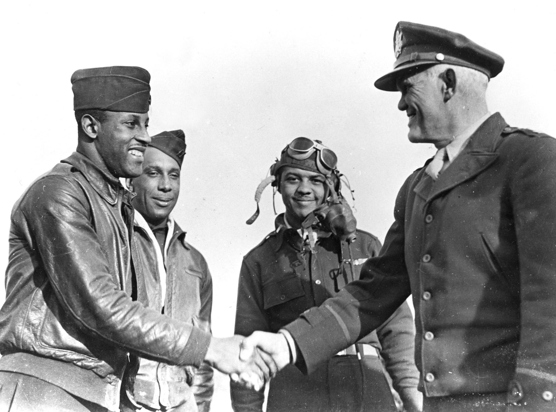 North Africa, 1943. Captain Charles B. Hall, first Tuskegee Airman to shoot down an enemy plane is congratulated by Major General John K. Cannon